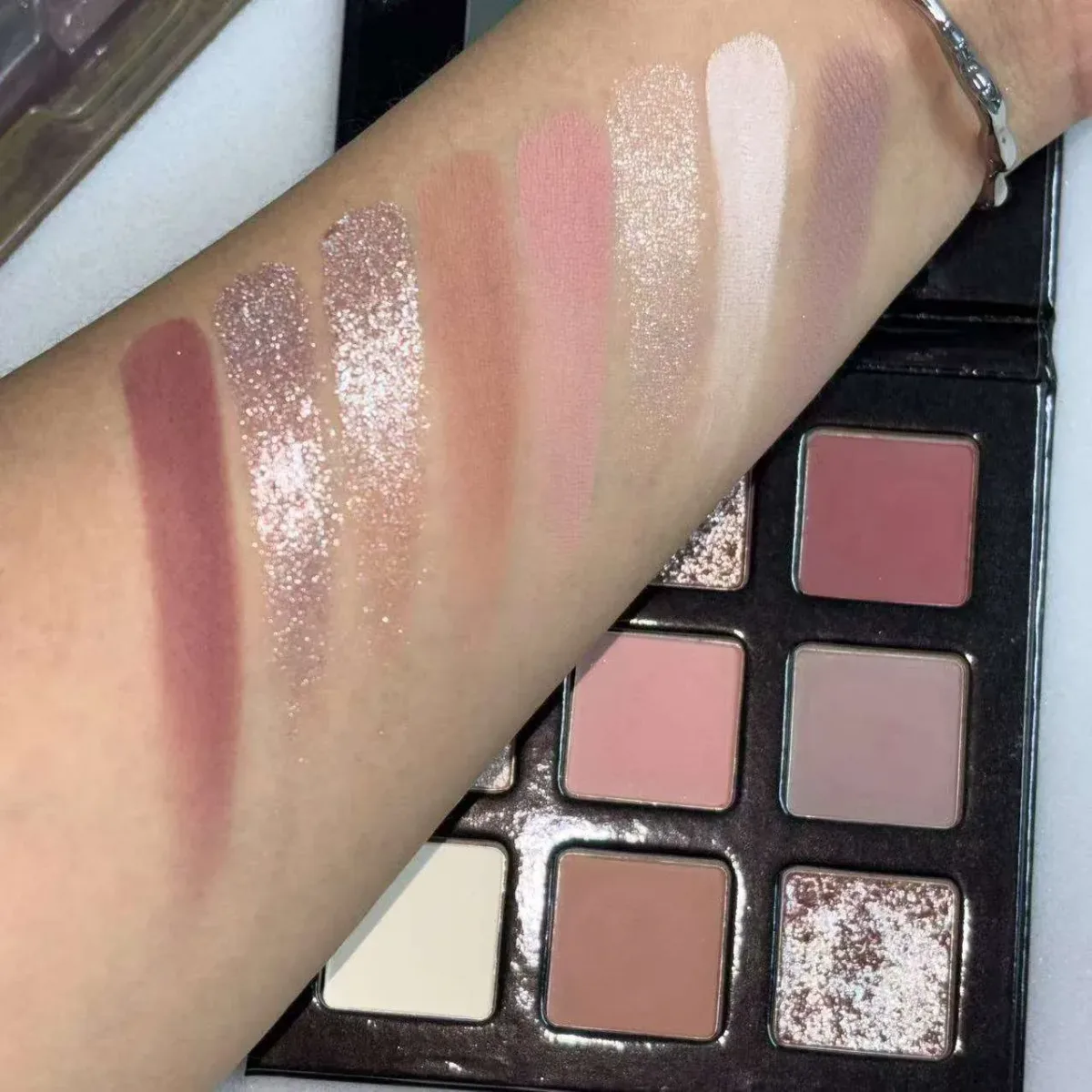 shimmer and matte swatches next to the neutral eyeshadow palette