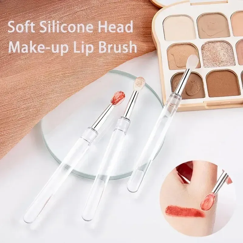 reusable silicone lip brushes next to an eyeshadow palette