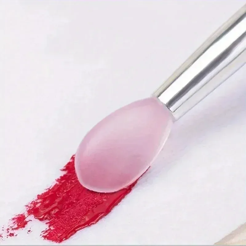 silicone tip of the lip brush spreading red lipstick