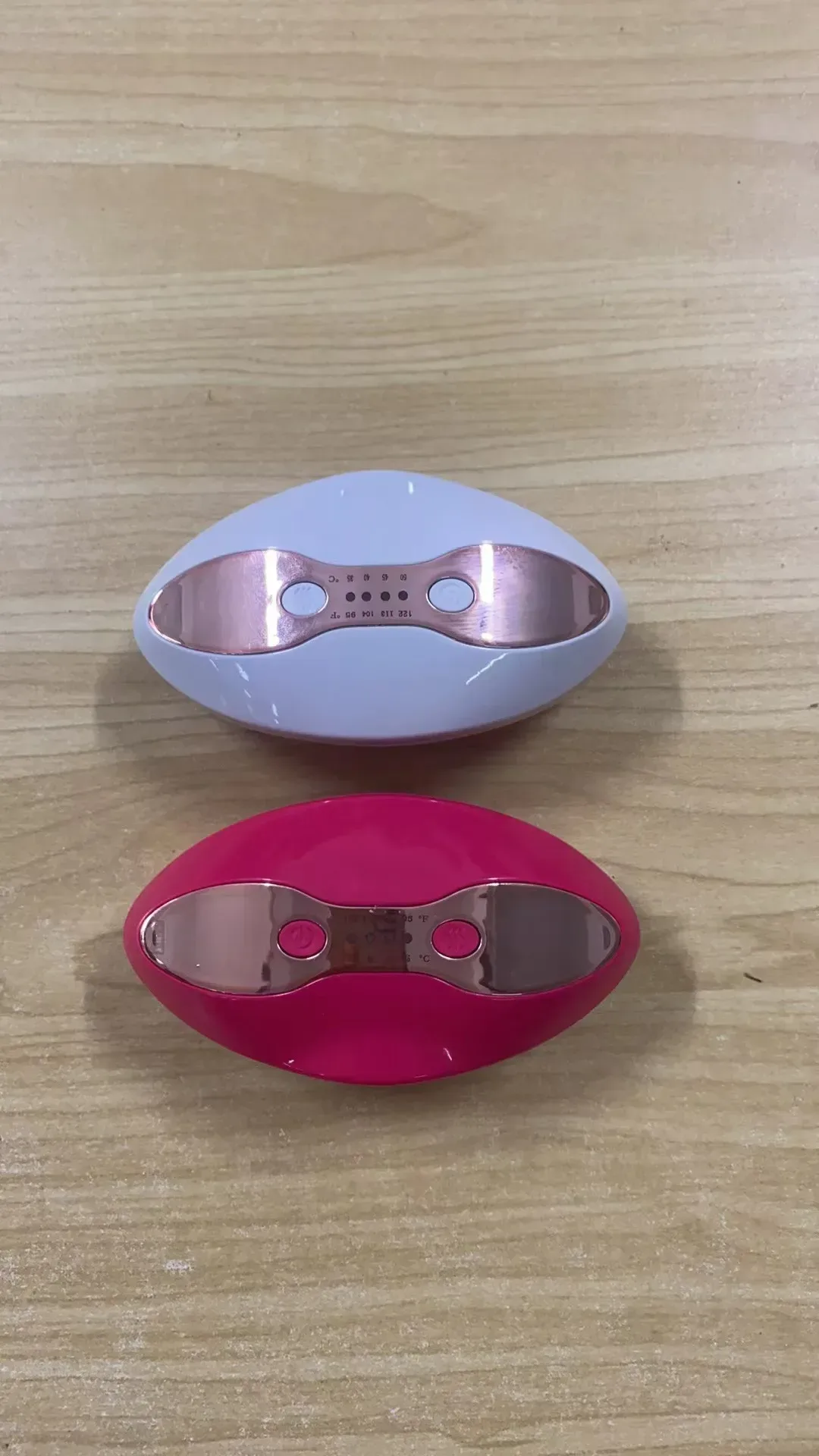 heated LED lip care devices in white and pink on a table